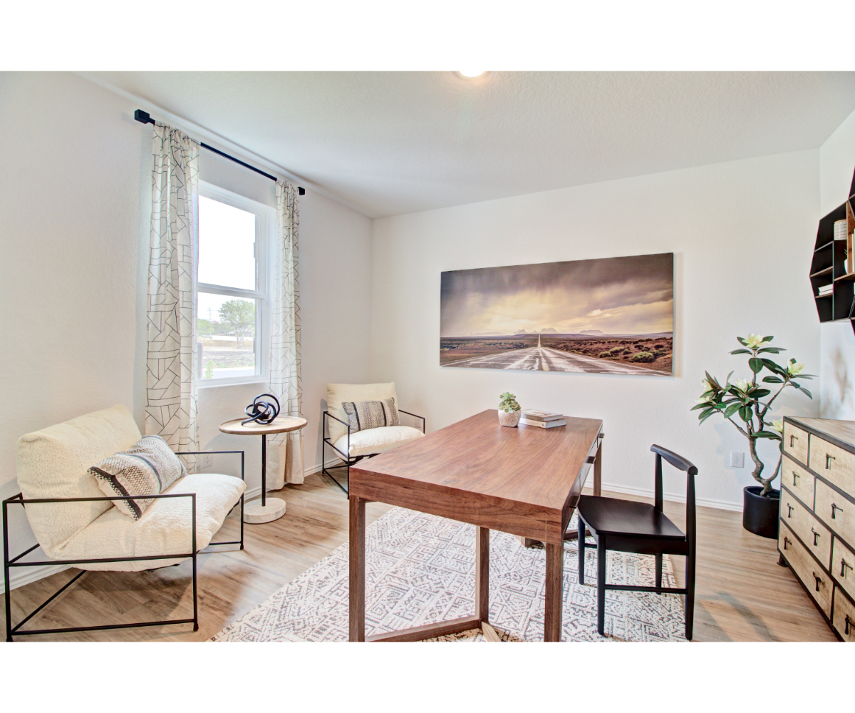 A living room with a table and chairs.