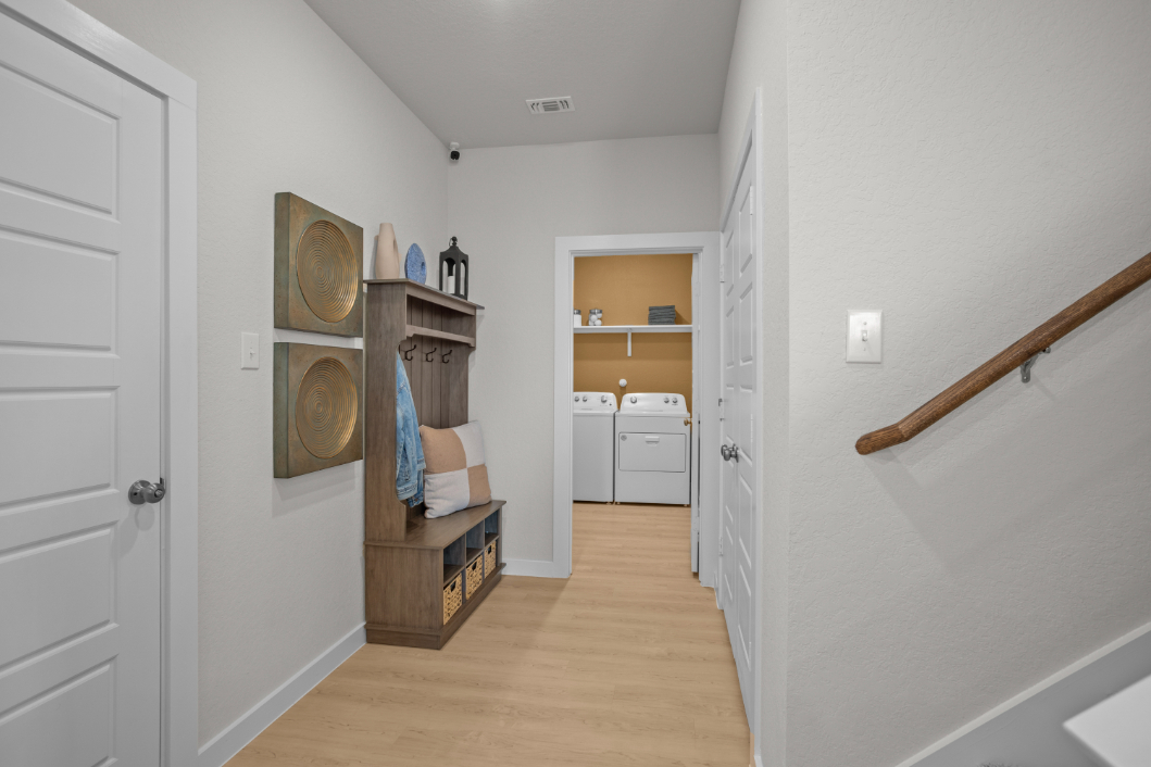 A room with a wood floor and a white door with a white door.