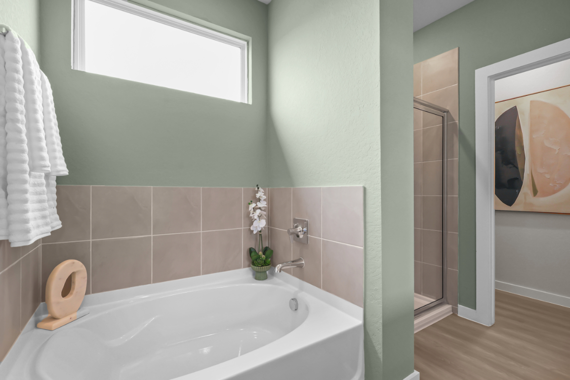 A bathroom with a tub and a toilet.