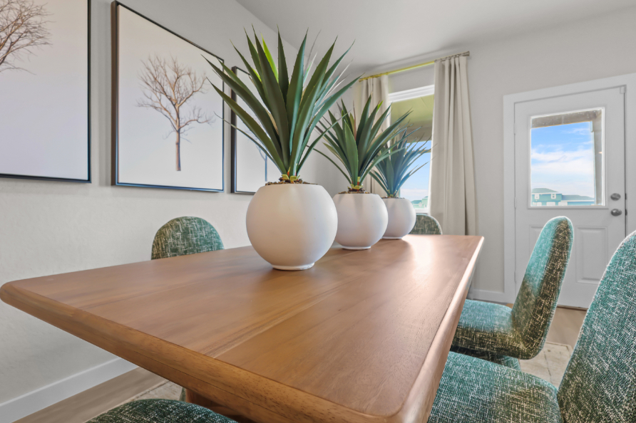 A table with a vase of plants.