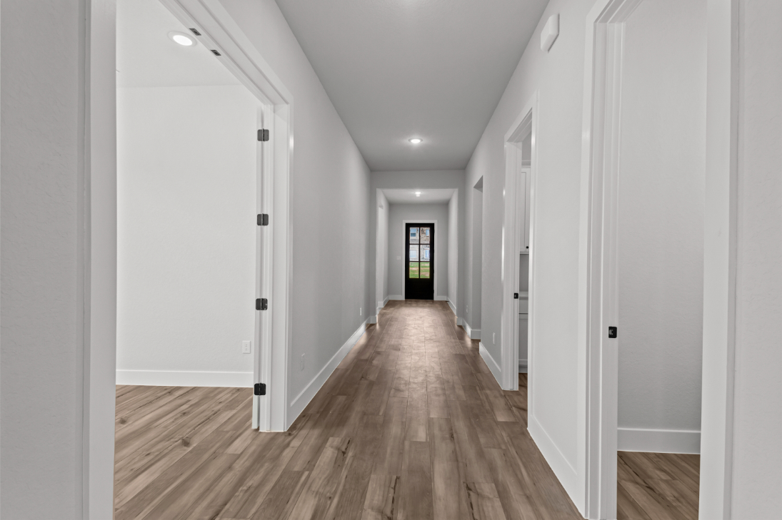 A hallway with white doors.