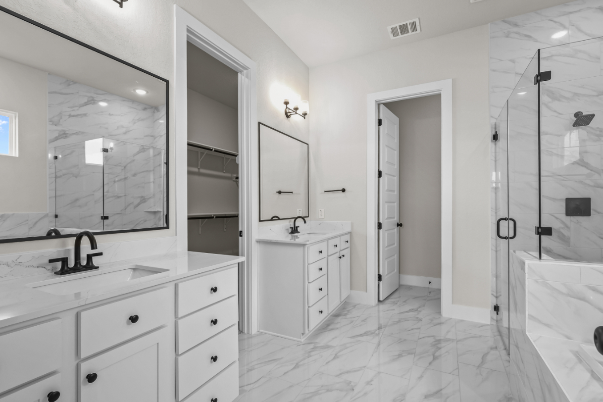 A bathroom with a tub sink and mirror.