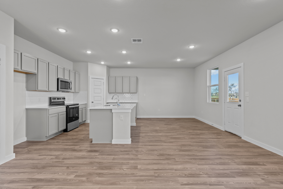 A kitchen with white cabinets.