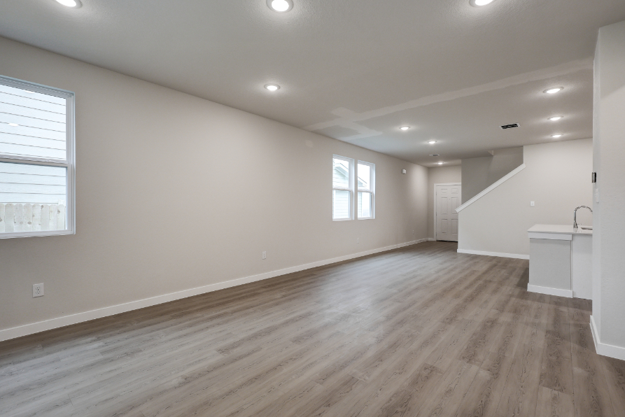 A room with a wood floor and a sink.