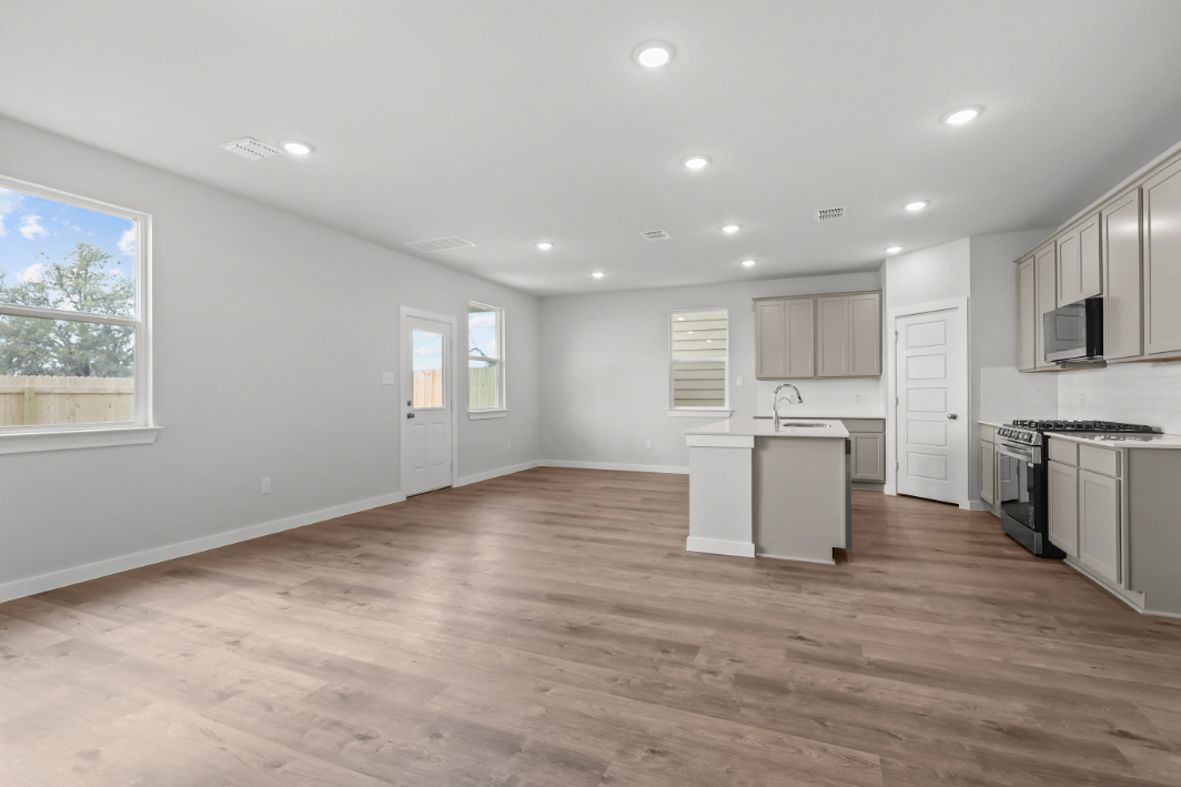 A large kitchen with white cabinets.