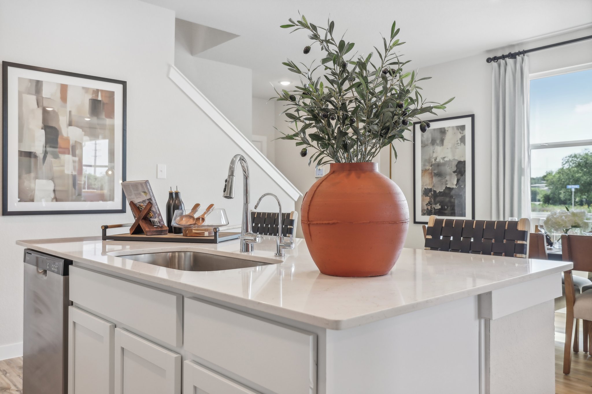 A kitchen with a vase of flowers.