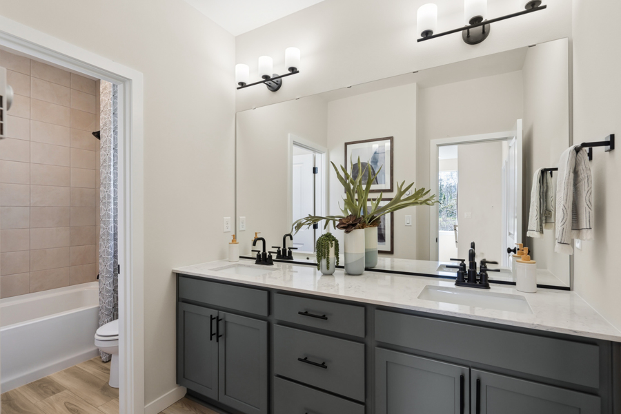 A bathroom with a tub sink and a toilet.