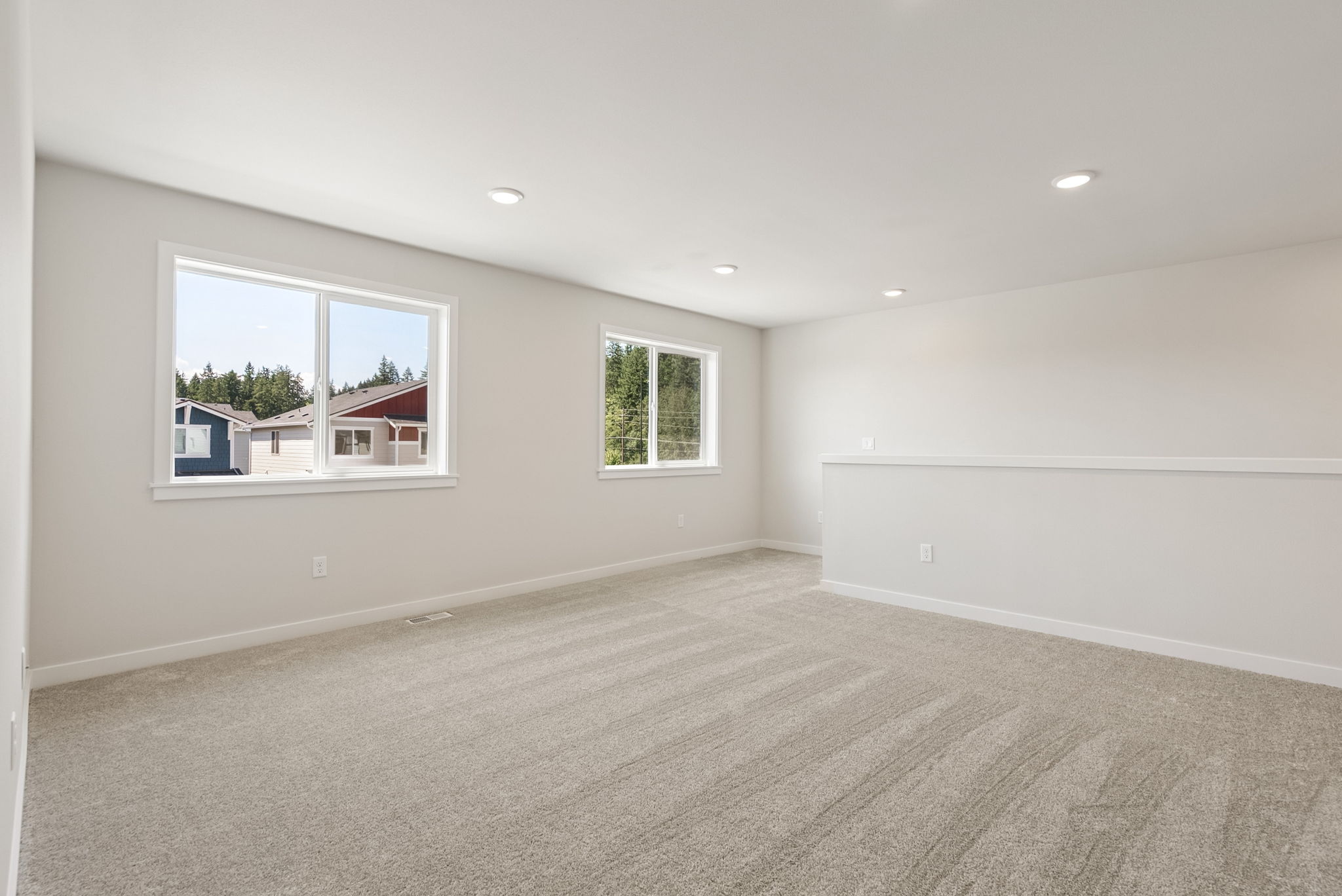 A room with a window and a carpet.