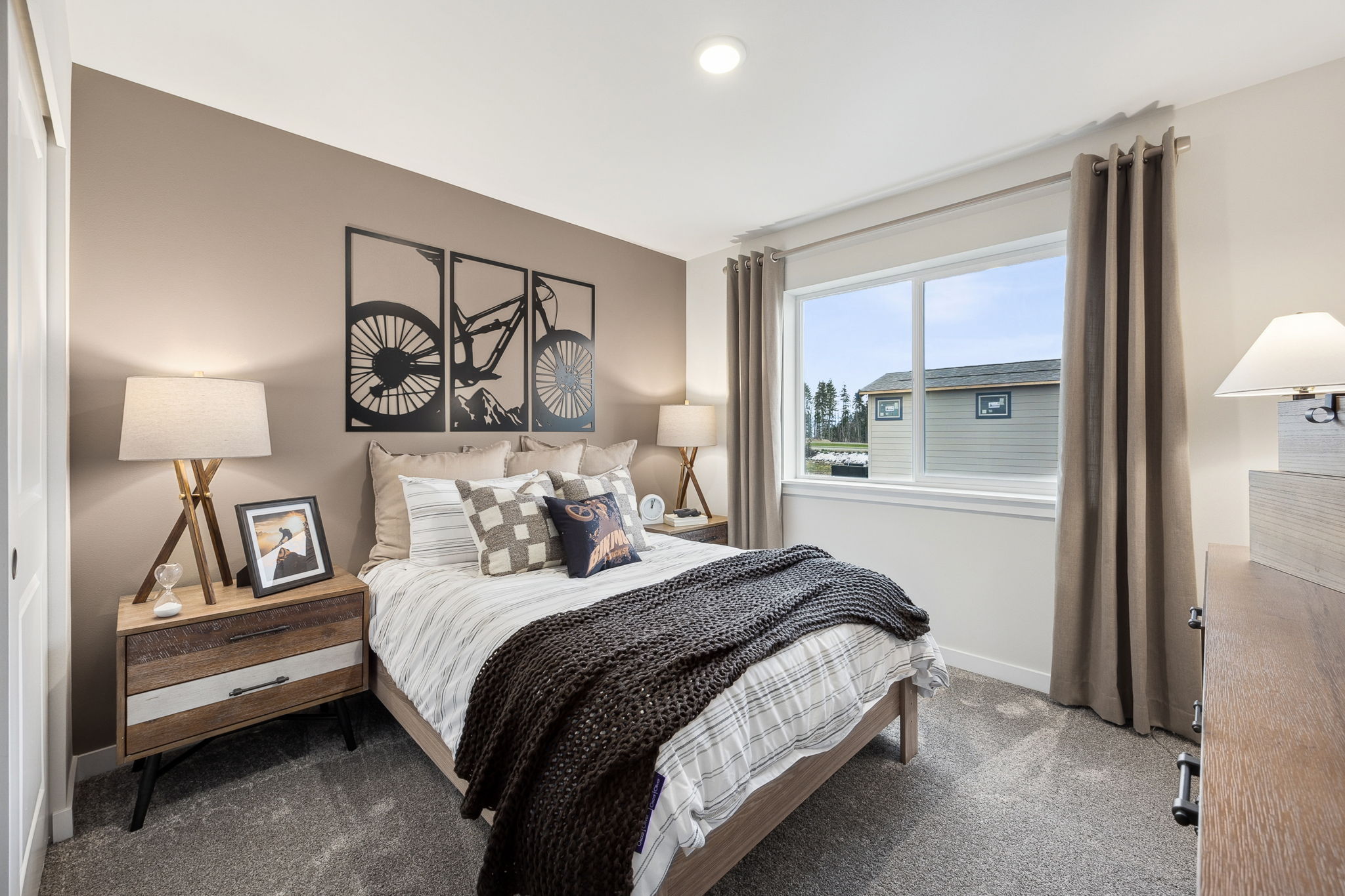 A bedroom with a large window.