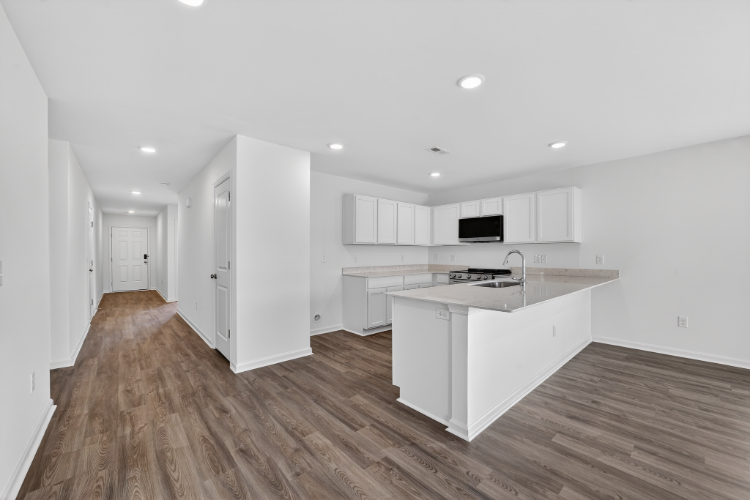 A kitchen with white cabinets.