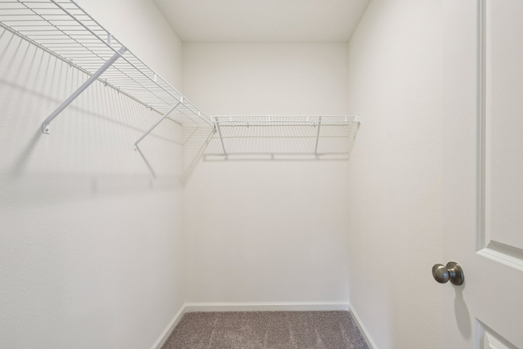 A white room with a metal railing.