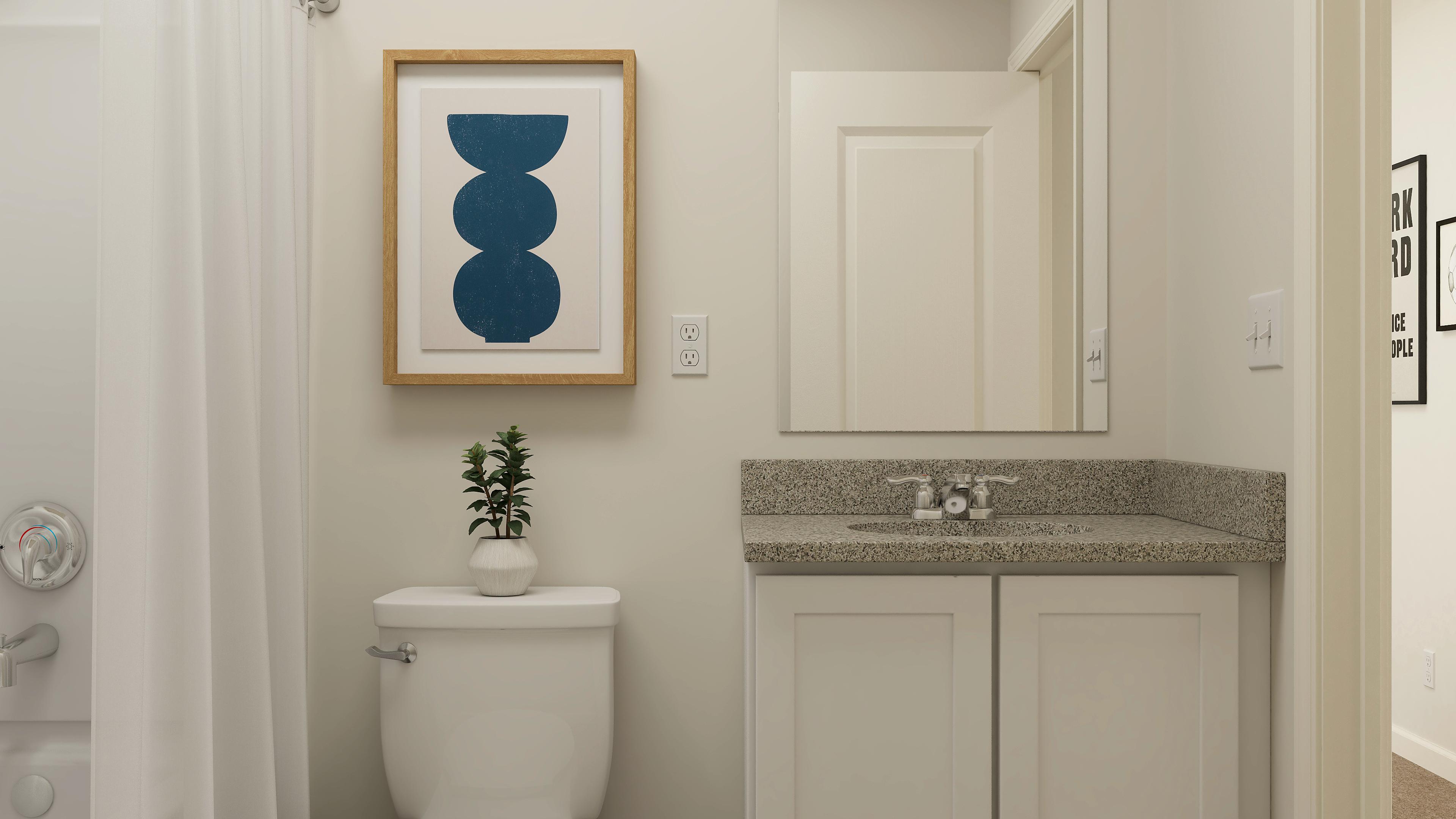 A bathroom with a painting on the wall.