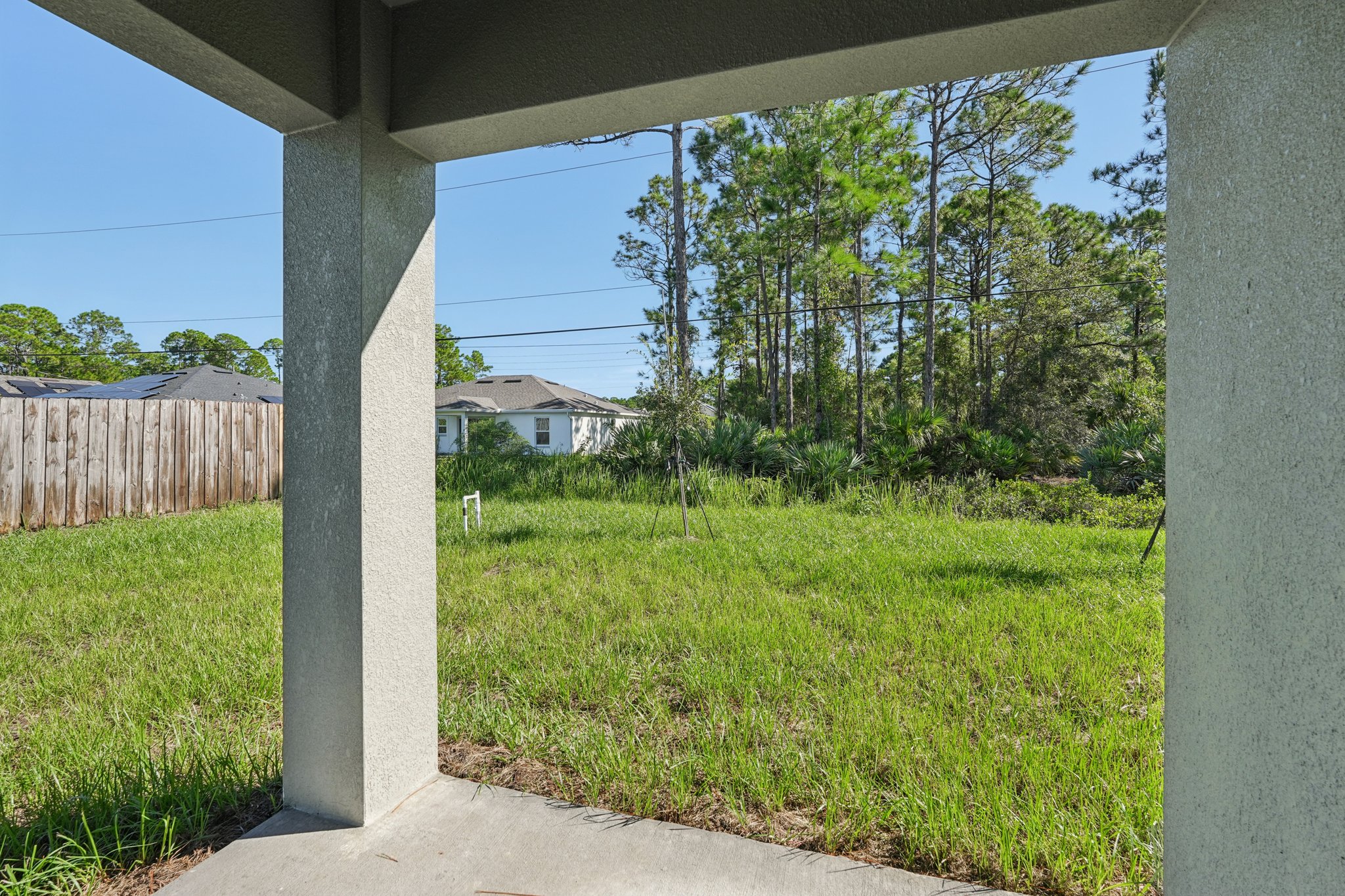 A view of a yard through a fence.