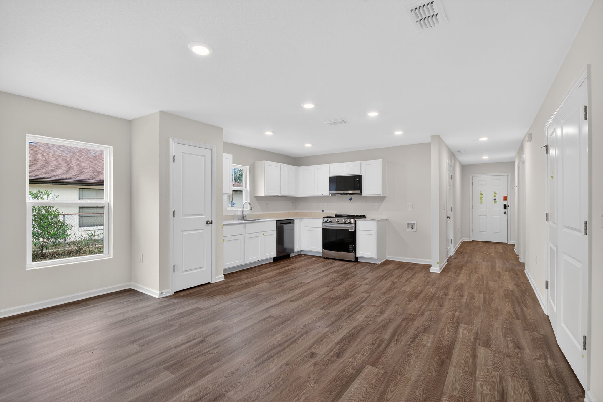 A large kitchen with white cabinets.