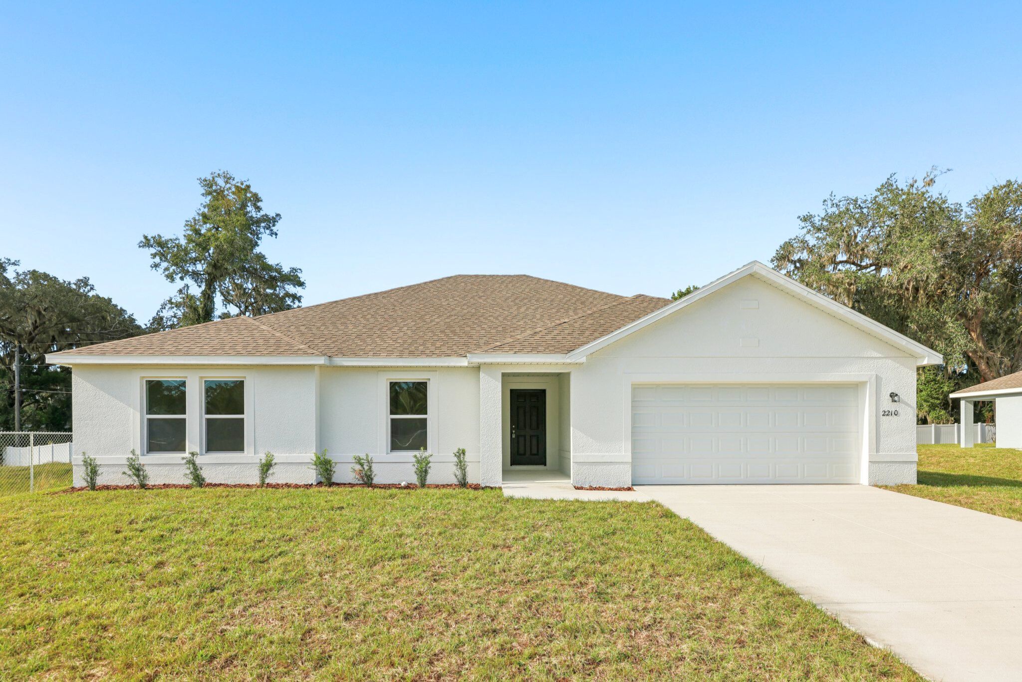 A white house with a garage.