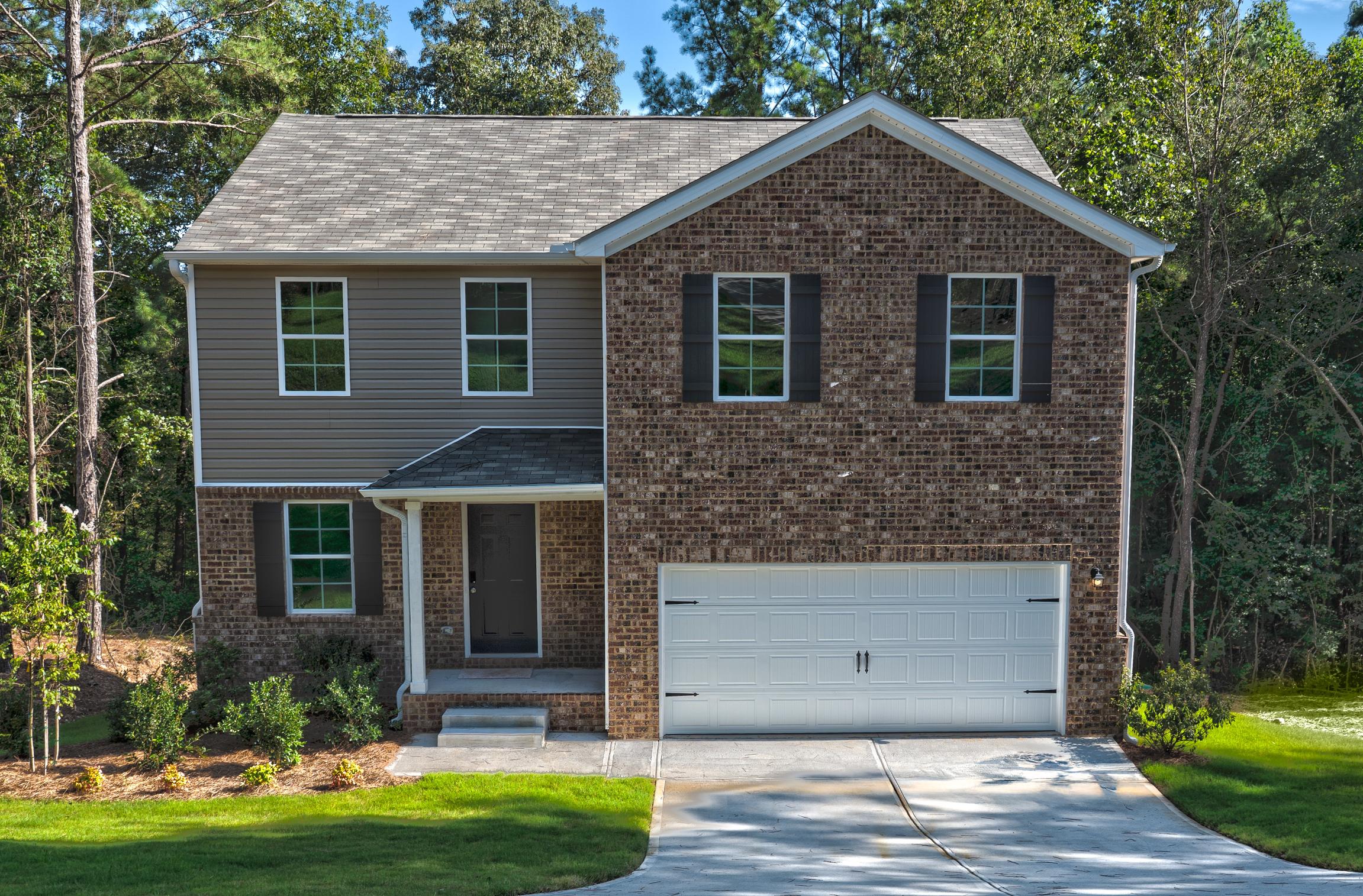 A brick house with a garage.