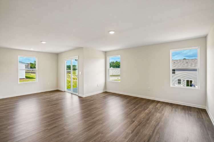 A room with a wood floor and a wood floor with posters on the wall.
