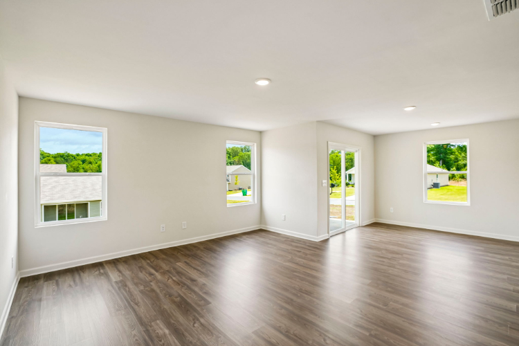 A room with a wood floor and white walls.