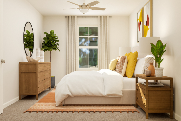 A living room with a white couch and a fan.
